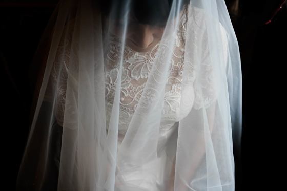 View from above of bride beneath her veil by Aela Photography