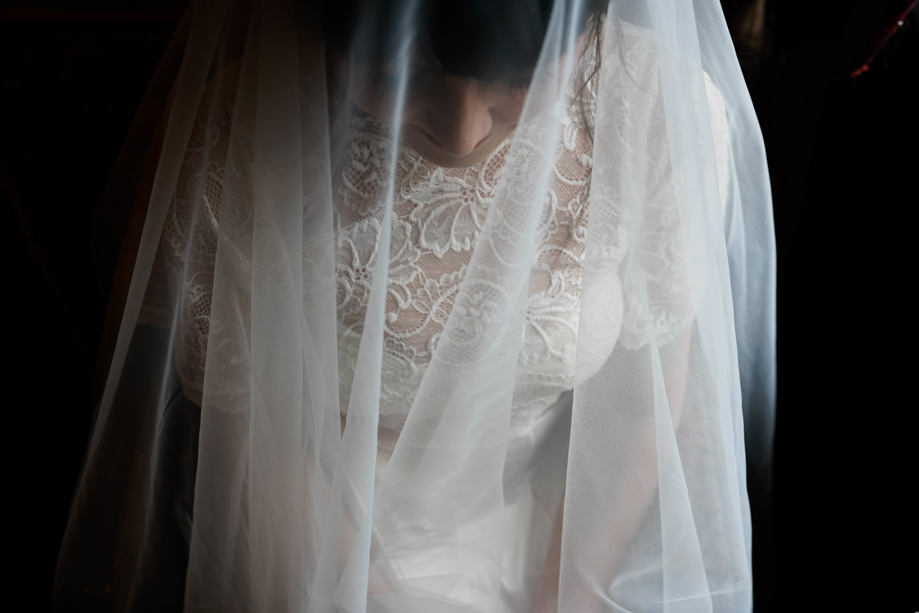 View from above of bride beneath her veil by Aela Photography