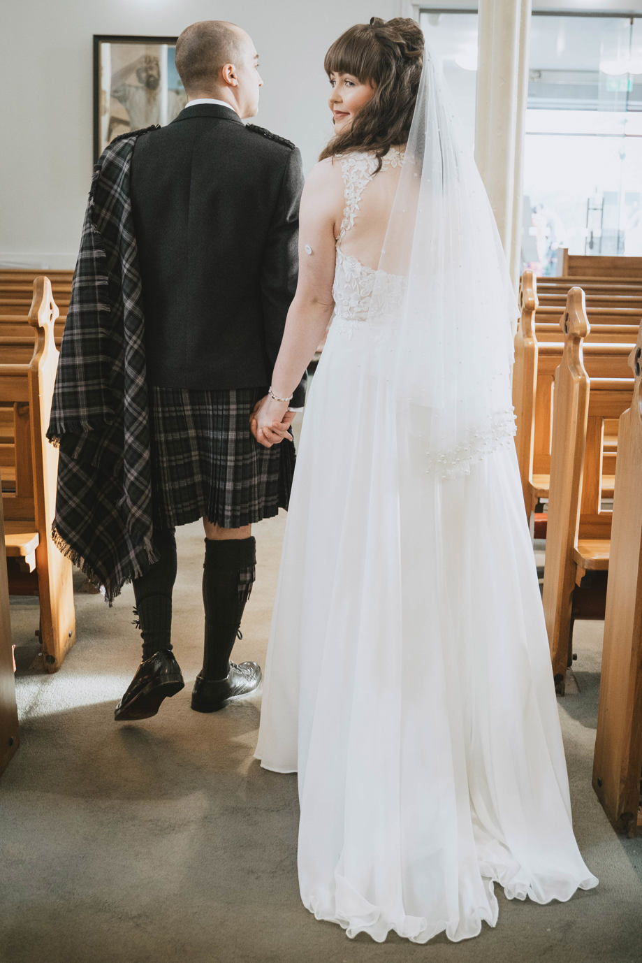 Bride looks back as she walks down aisle