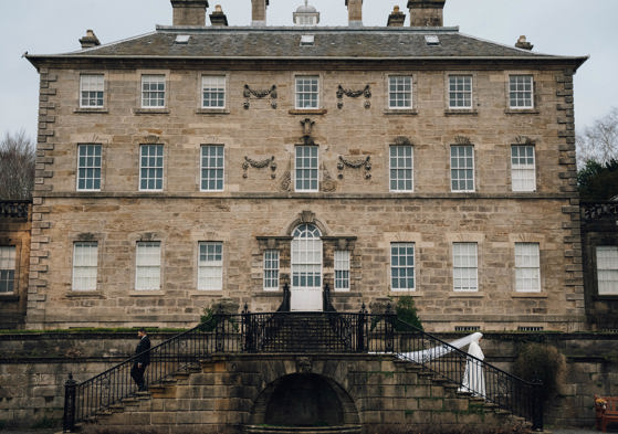 View of venue with bride walking down outdoor steps