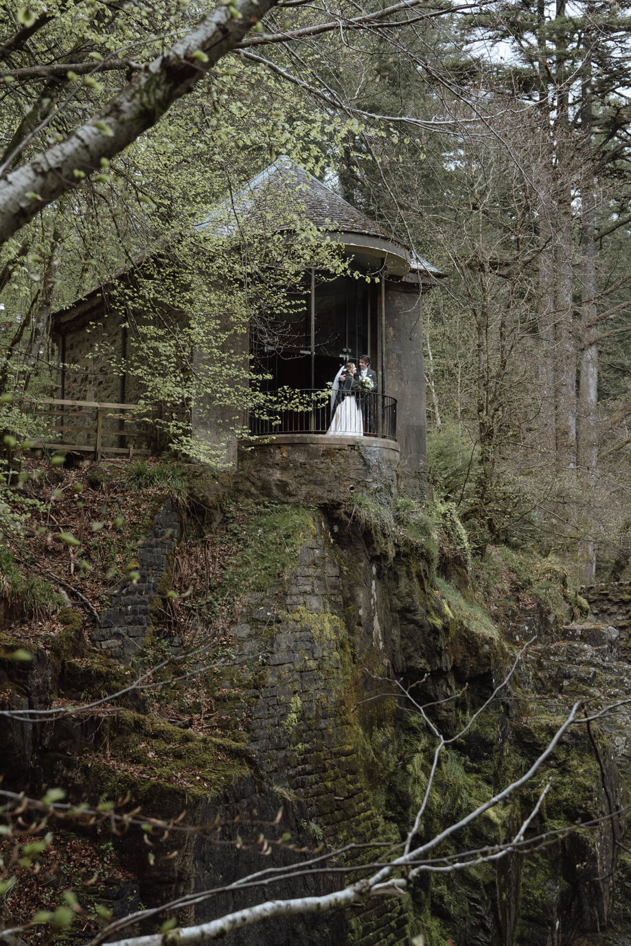 Bride and groom in woodland ruins by Aela Photography