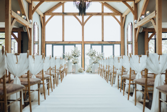 View from behind of rustic, boho wedding ceremony