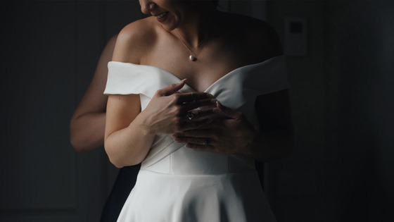 Artistic shot of bride getting dressed