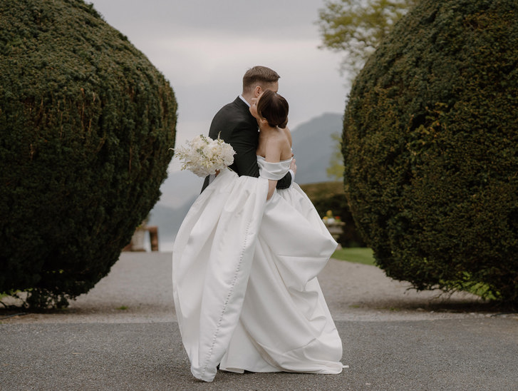 Groom kisses brides hand at top table