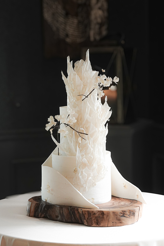 Three-tier white cake with textured marble fondant pattern to match, carefully hand-dyed colour matched the wedding dress colour and dedicate handmade wafer paper cherry blossoms by YiShi Cake