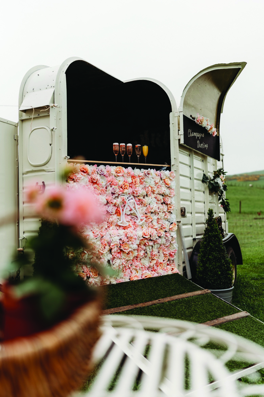 Boho flower-covered horsebox gin bar for hen parties at Maycroft Retreat.