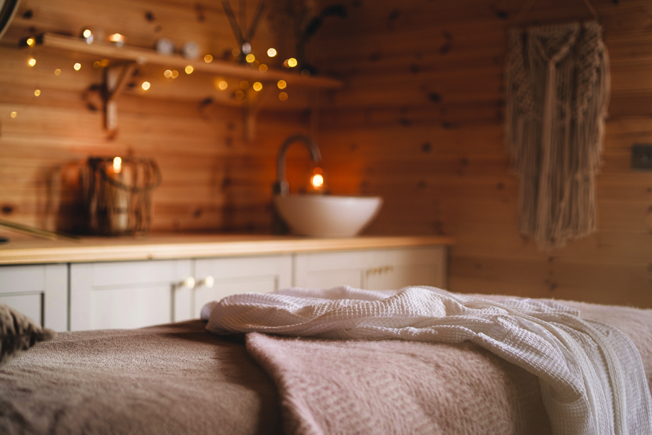 Inside a spa treatment room at Maycroft Retreat, lit by warm fairy lights.
