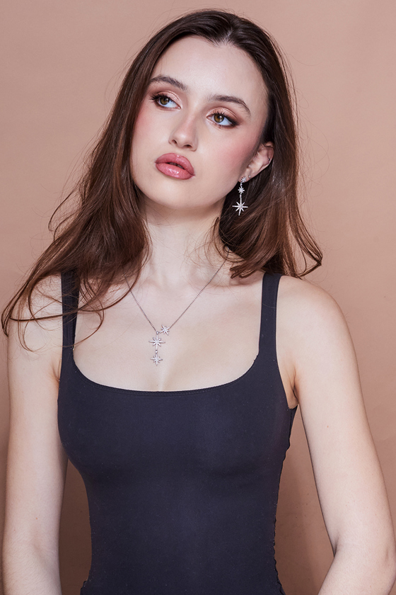 Photoshoot image of a dusky pink background and a young girl with brown hair, makeup by Jill Rowan Makeup.
