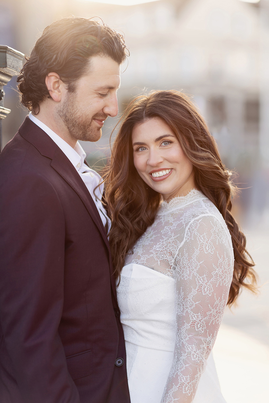 Groom smiling at bride, with bride smiling at camera with makeup by Jill Rowan.