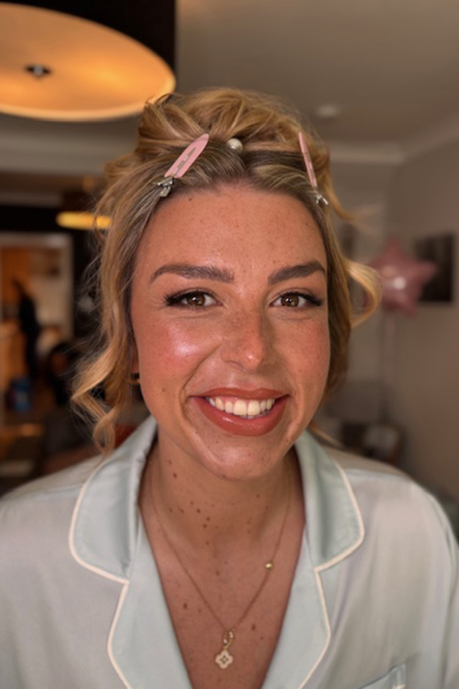 Bride smiles as she gets ready for her wedding, makeup by Jill Rowan Makeup.