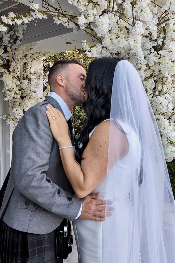 Bride and groom share a kiss, captured by Millar Moments.