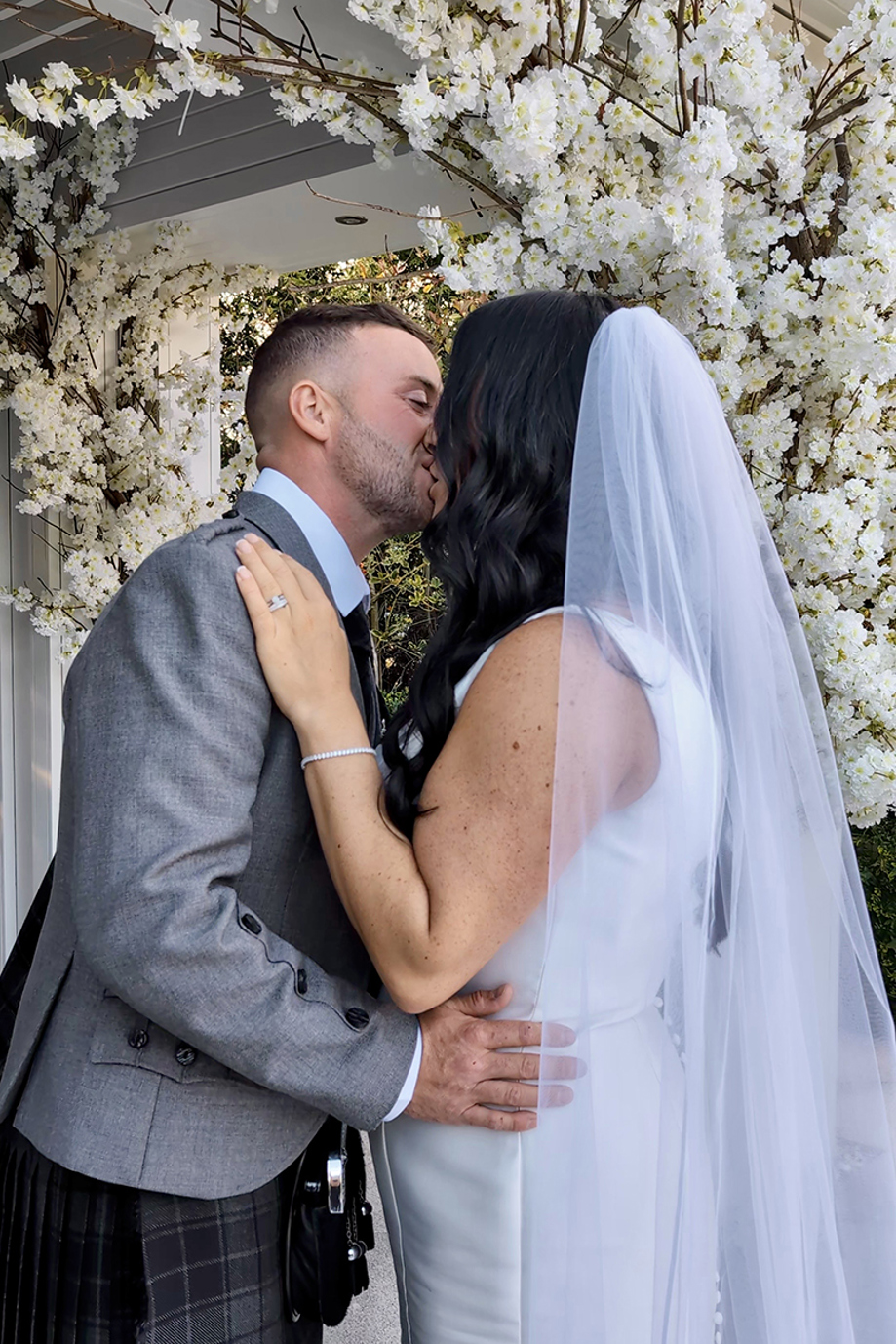 Bride and groom share a kiss, captured by Millar Moments.