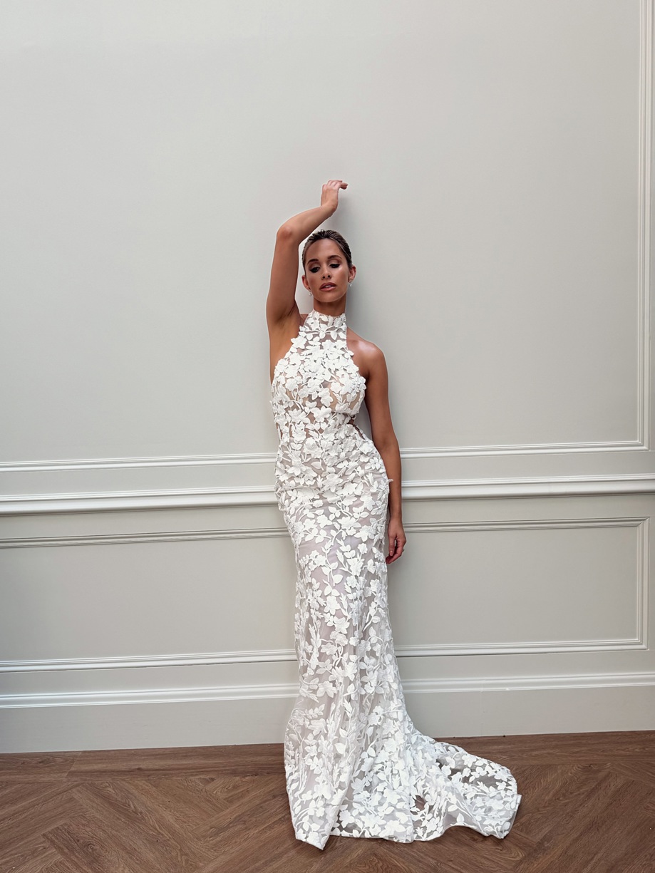 Emily Shak poses up against wall in halter neck floral wedding dress, captured by Ivoura.