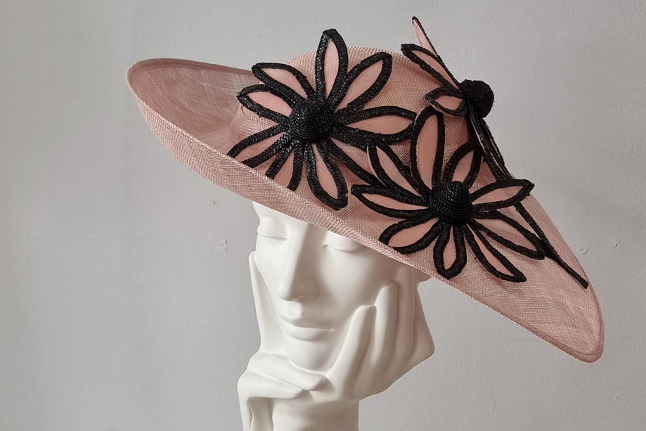 Pink hat with black flowers at Hazel Goodwin Millinery in Glasgow