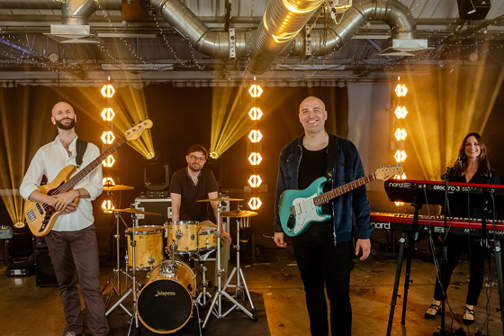 Members of Boulevard pose in front of bright lights, book through Hireaband