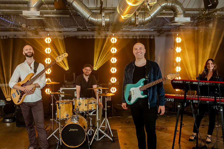 Members of Boulevard pose in front of bright lights, book through Hireaband