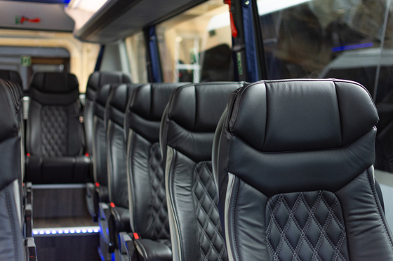 Black leather reclining chairs in one of Anderson Black Executive Travel's modern coaches