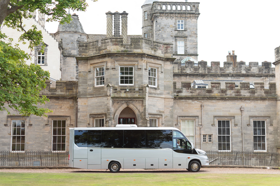 Anderson Black Executive Travel midicoach parked next to wedding venue