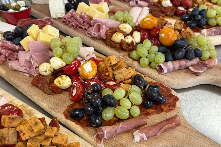 Wedding grazing boards with charcuterie, cheeses, grapes and antipasti by The Tasty Hog Company catering