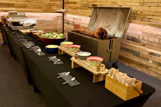 Rustic hog roast catering station with salads and sides set up for a Scottish wedding by The Tasty Hog Company