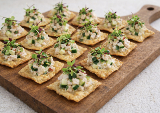 Seafood canapé bites on crisp crackers with cucumber and microgreens served at a Scottish wedding by The Tasty Hog Company