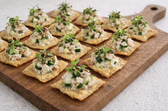 Seafood canapé bites on crisp crackers with cucumber and microgreens served at a Scottish wedding by The Tasty Hog Company