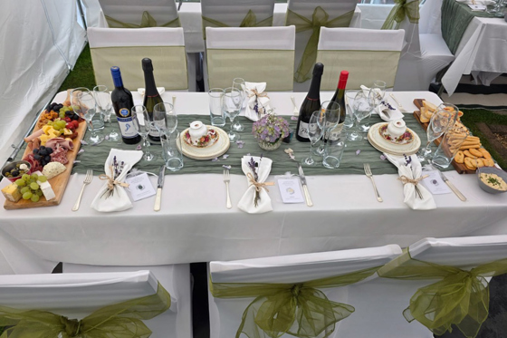 Wedding reception table styling with grazing boards, wine and place settings at a marquee celebration