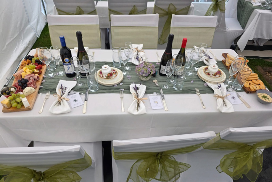 Wedding reception table styling with grazing boards, wine and place settings at a marquee celebration