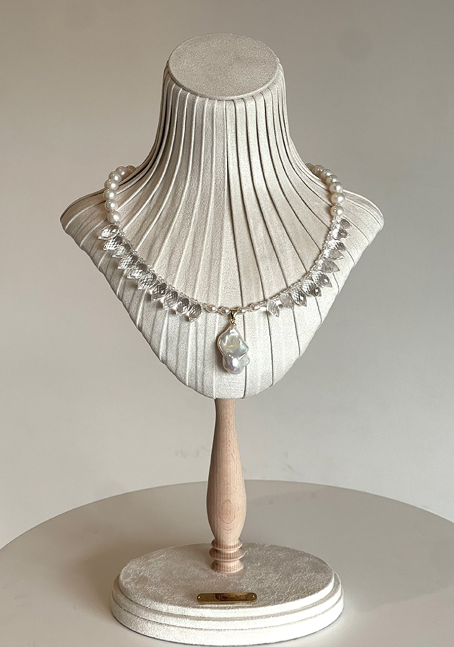 Pearl and crystal bridal necklace with baroque pearl pendant on display stand