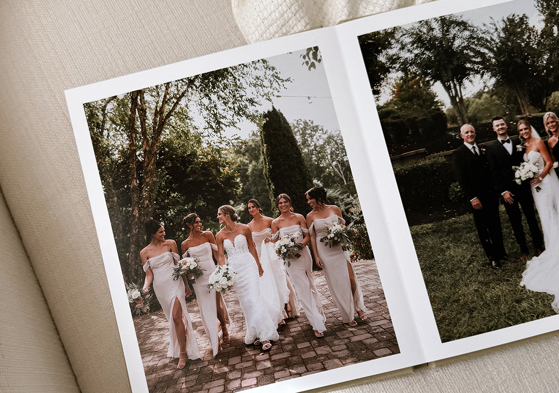Layflat wedding photobook by Inkifi showing bridal party and family wedding portraits on high-quality printed pages