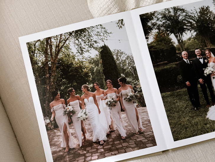 Layflat wedding photobook by Inkifi showing bridal party and family wedding portraits on high-quality printed pages