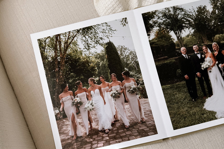Layflat wedding photobook by Inkifi showing bridal party and family wedding portraits on high-quality printed pages