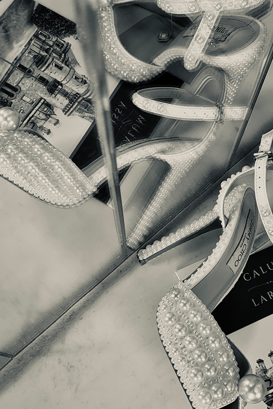 Black and white close-up of pearl embellished wedding heels and bridal accessories styled for wedding content creation by Effortless Ivory Weddings