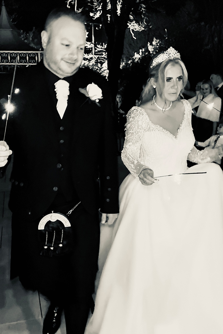 Black and white wedding content image of bride and groom holding sparklers during evening celebrations captured by Effortless Ivory Weddings