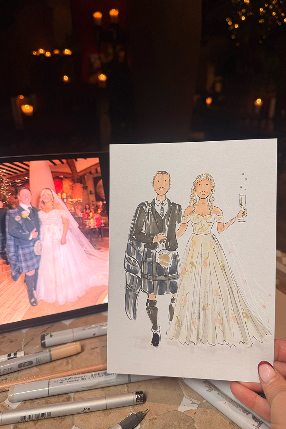 Finished hand-drawn illustration displayed beside a reference photo of a bride and groom at their wedding.