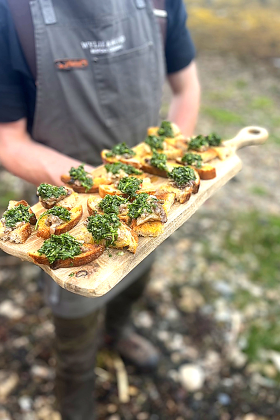 Handmade crostini canapés topped with herbs and seasonal ingredients, prepared by Wylie & Wood for Scottish events.