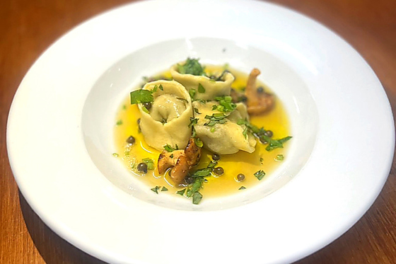 Handmade filled pasta served with butter sauce and herbs as part of a fine dining menu by Wylie & Wood.