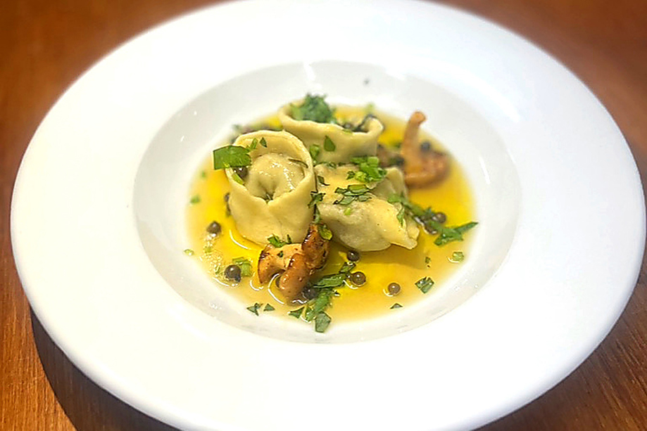 Handmade filled pasta served with butter sauce and herbs as part of a fine dining menu by Wylie & Wood.