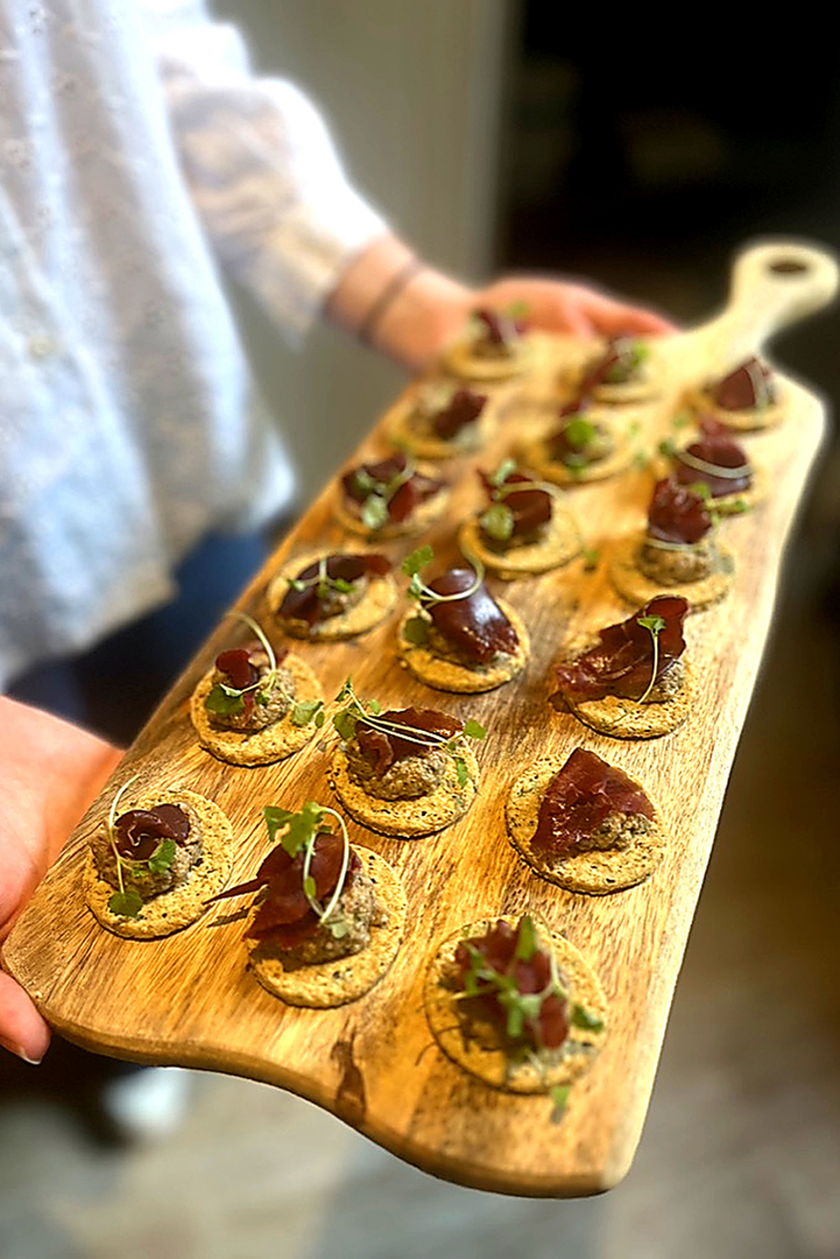 Luxury wedding canapés served on a wooden board by Wylie & Wood, featuring Scottish ingredients and handcrafted bites for events.