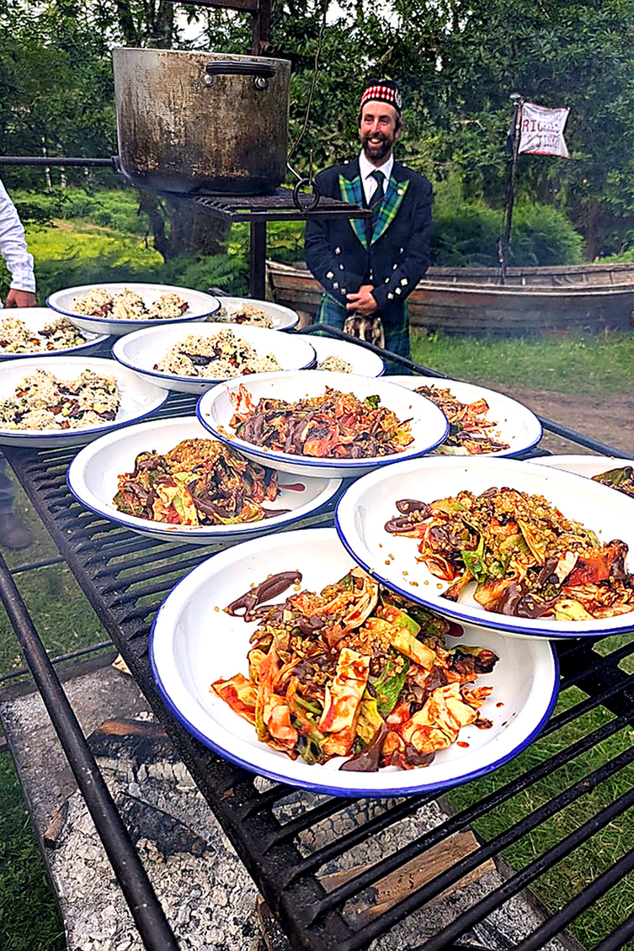 Outdoor catering plates prepared over open fire cooking by Wylie & Wood at a Scottish event.