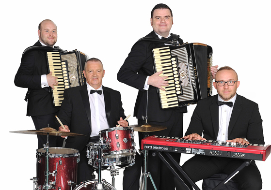 The Liam Stewart Band posing with instruments including accordion, keyboard and drums.