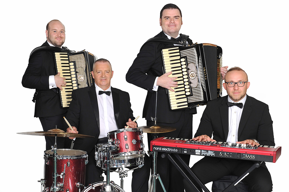 The Liam Stewart Band posing with instruments including accordion, keyboard and drums.