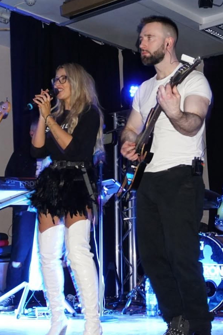 Laura Purdue Wedding Vocalist performing on stage with a guitarist at a live wedding entertainment set