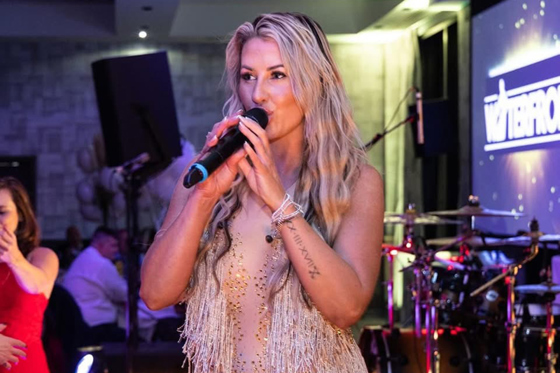 Laura Purdue Wedding Vocalist singing live with a band during a wedding reception
