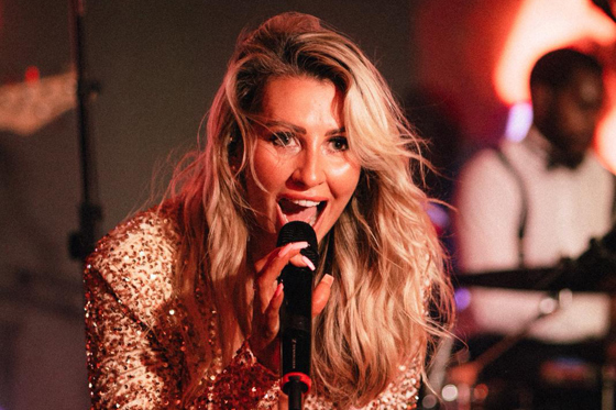 Laura Purdue Wedding Vocalist singing live during a high-energy wedding reception