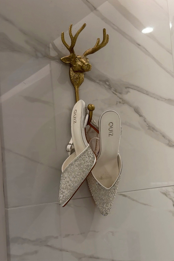 Navae Creative wedding content creator detail shot of sparkly bridal shoes on a gold stag hook