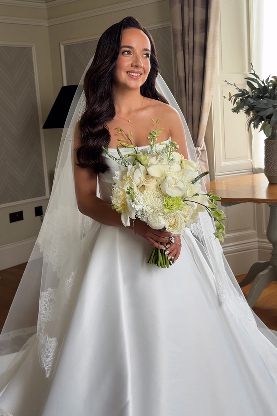 Navae Creative wedding content creator footage of a bride in a satin wedding dress holding a white bouquet