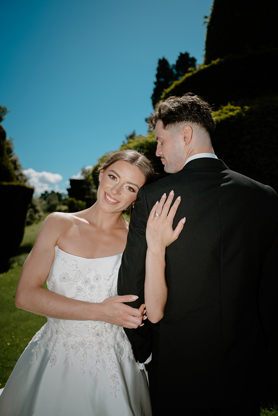 Bride showing her engagement ring during outdoor wedding portraits by Kamila Pickles Photography