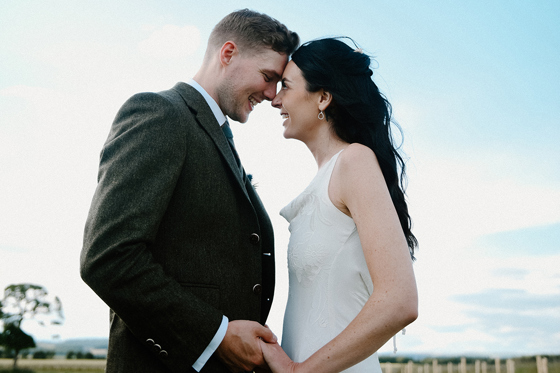 Scottish wedding couple holding hands during relaxed outdoor portraits by Kamila Pickles Photography