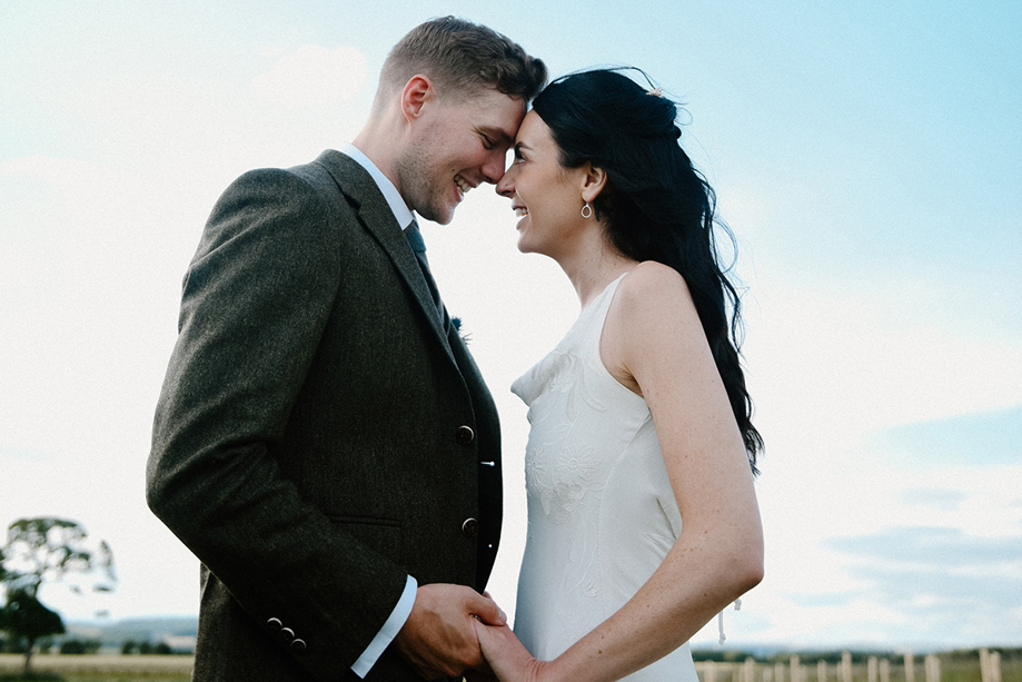 Scottish wedding couple holding hands during relaxed outdoor portraits by Kamila Pickles Photography